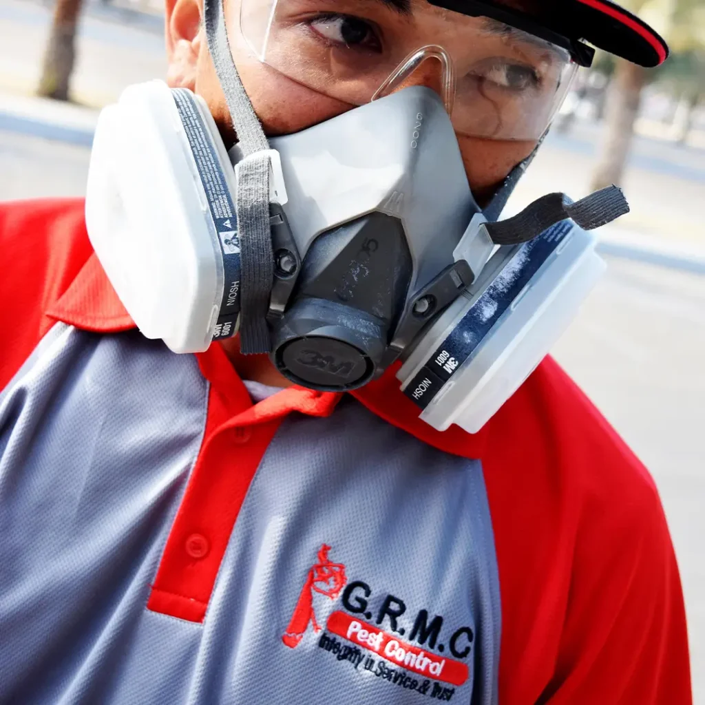 Close-up of a GRMC Pest Control Expert with safety mask and goggles on.